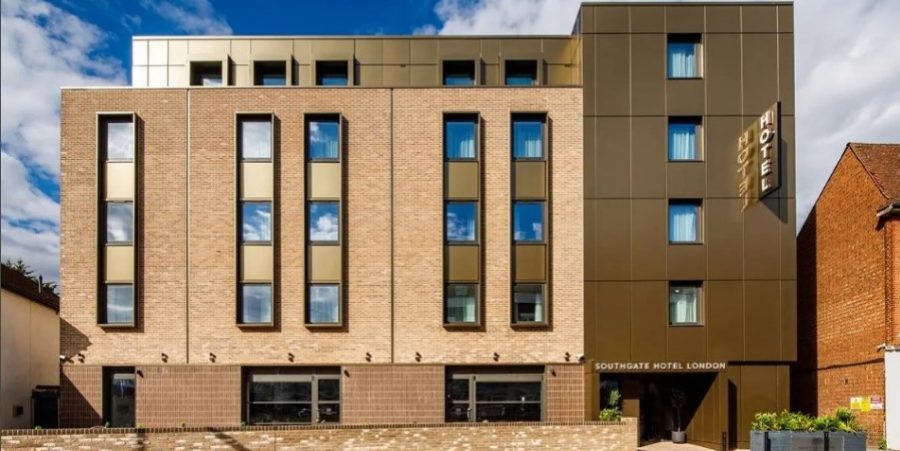 A brown brick hotel featuring multiple windows, showcasing a classic architectural design.
